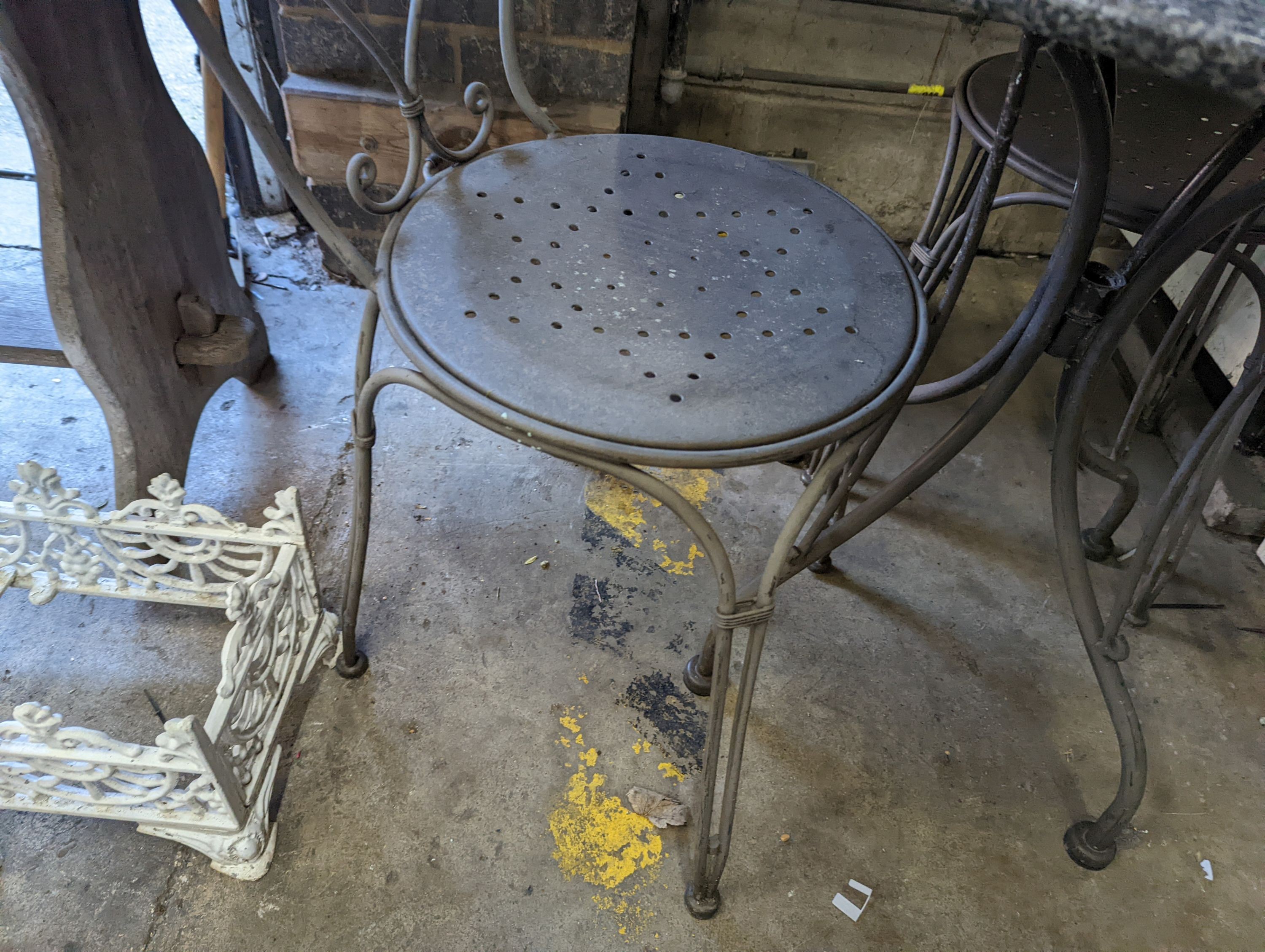 A circular stone top garden table, diameter 75cm, height 72cm and two chairs